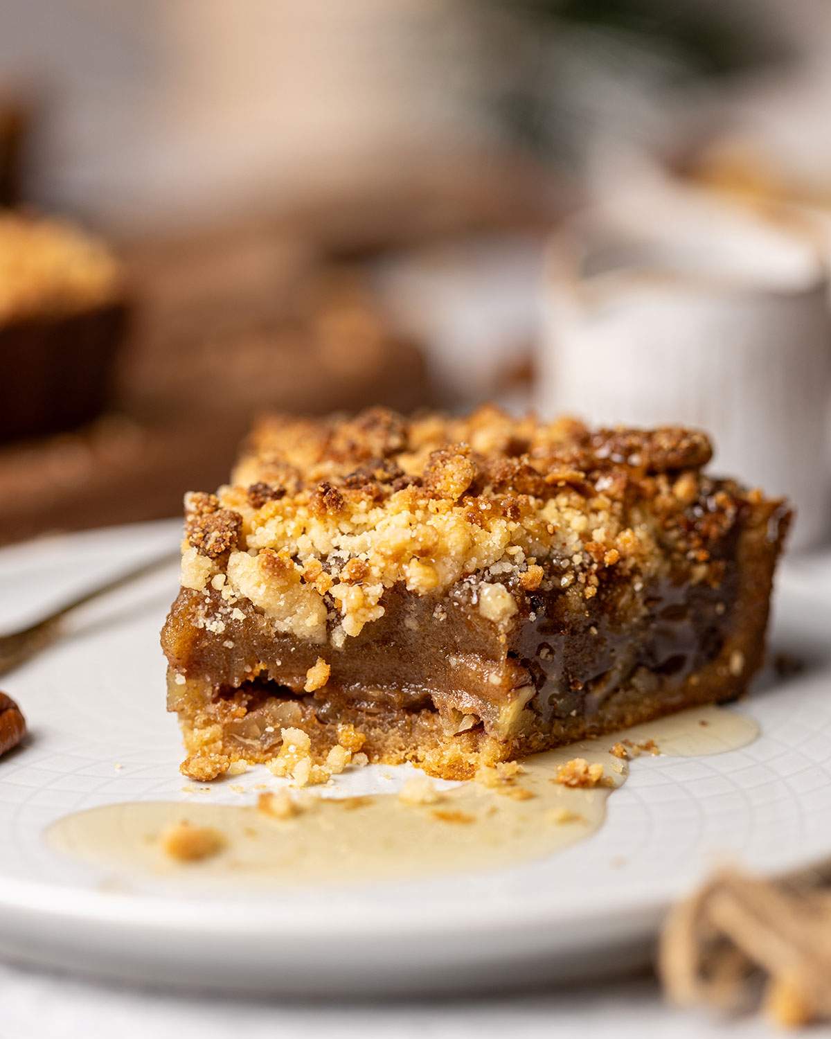 Vegan date caramel tart slice with maple syrup drizzle.