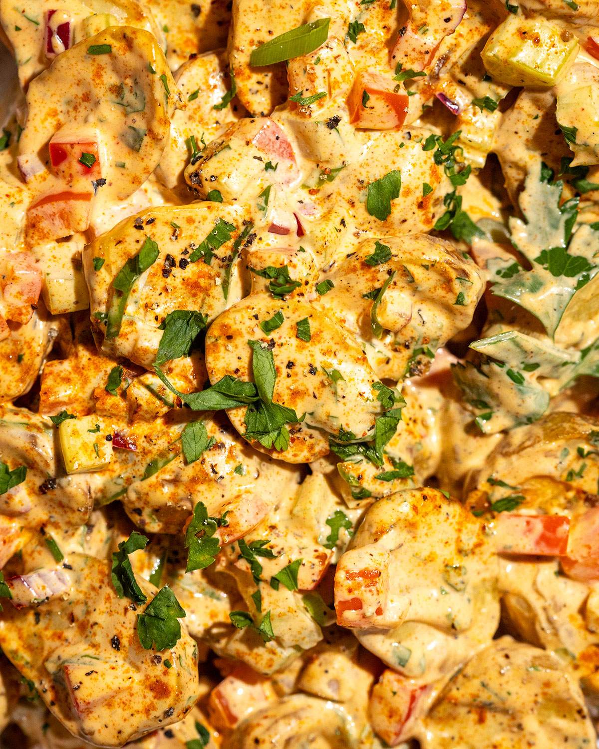 Detailed close-up of Cajun potato salad with tender potatoes coated in a creamy dressing.