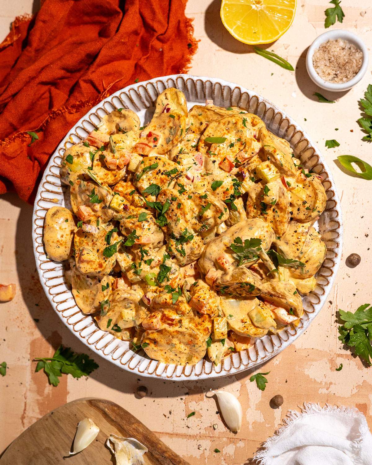 Cajun potato salad served in a large bowl with roasted potatoes, green onions and creamy Cajun dressing.