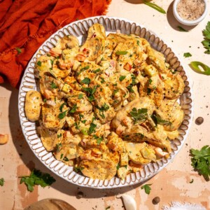 Cajun potato salad recipe with roasted potatoes, creamy dressing and fresh herbs.