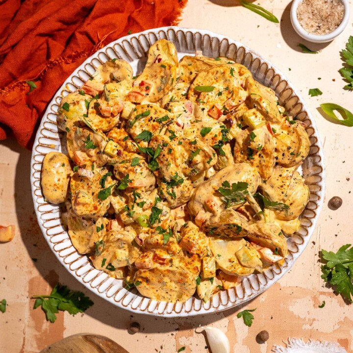 Cajun potato salad recipe with roasted potatoes, creamy dressing and fresh herbs.